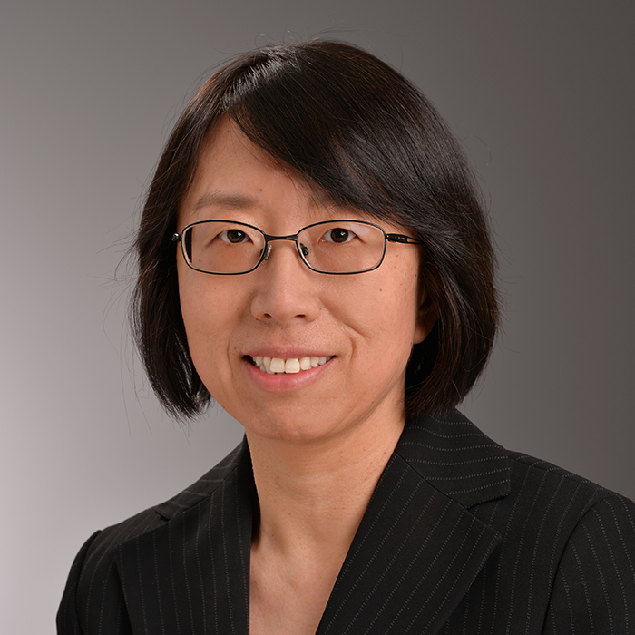 A portrait of Heidi Jinjuan Feng, an Asian female with dark hair, wearing glasses and a black suit.